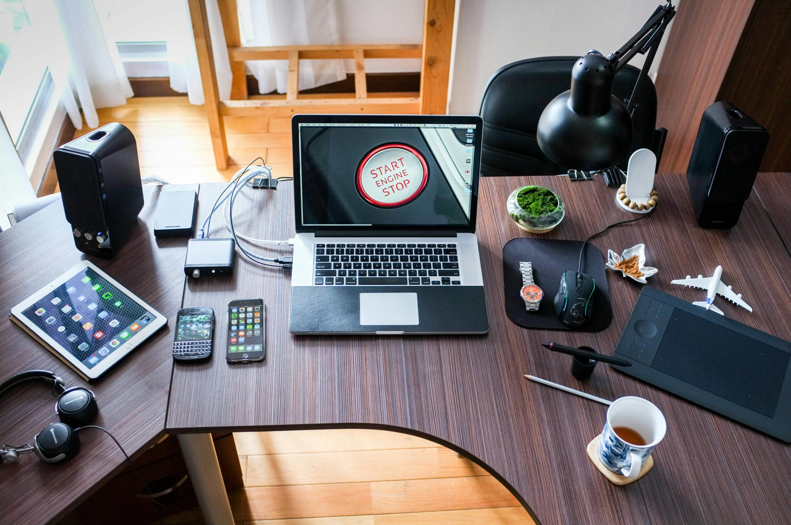 Workspace with a laptop and coffee at Doxa Digital Tech