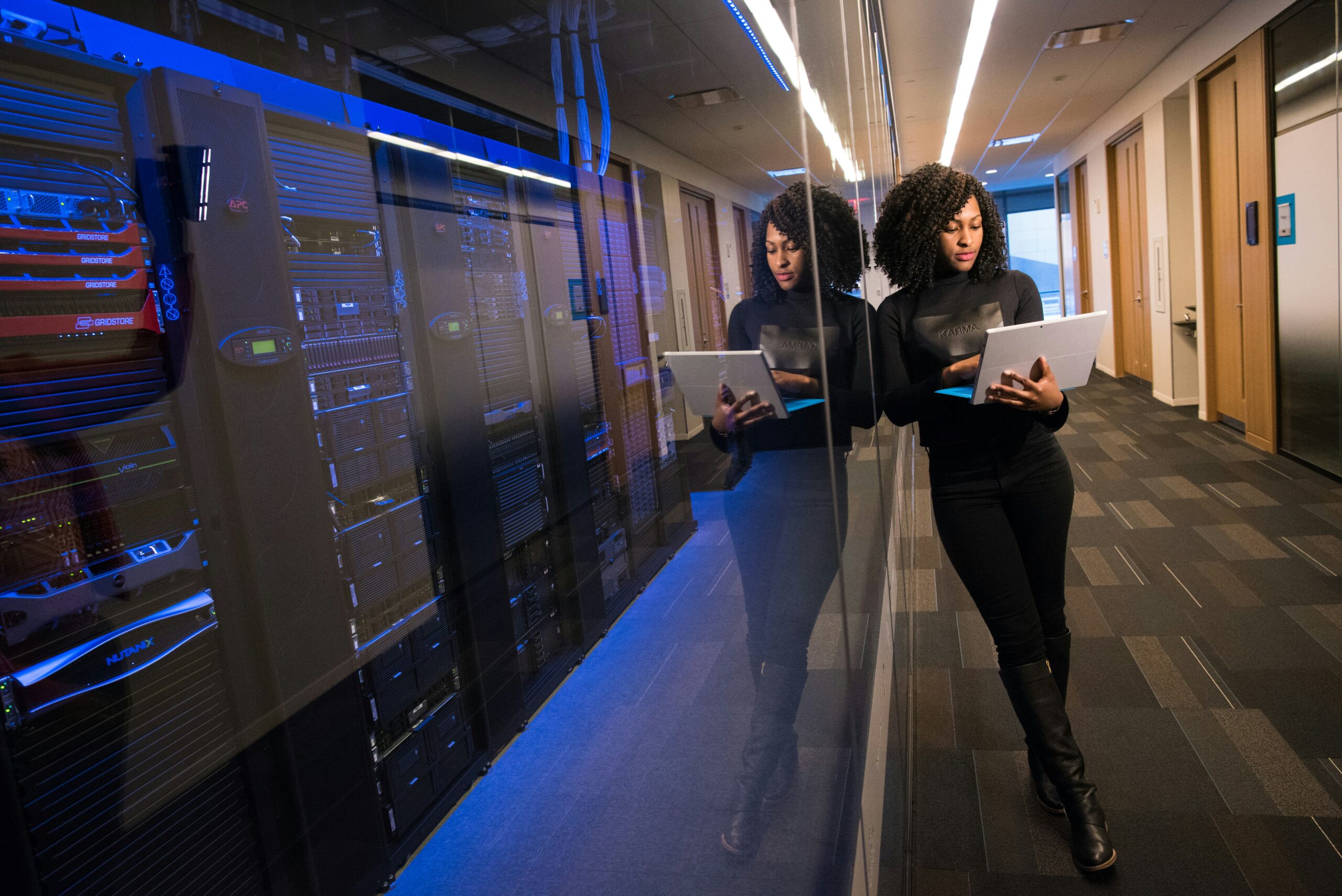 Doxa Digital Tech specialist standing in front of a server room